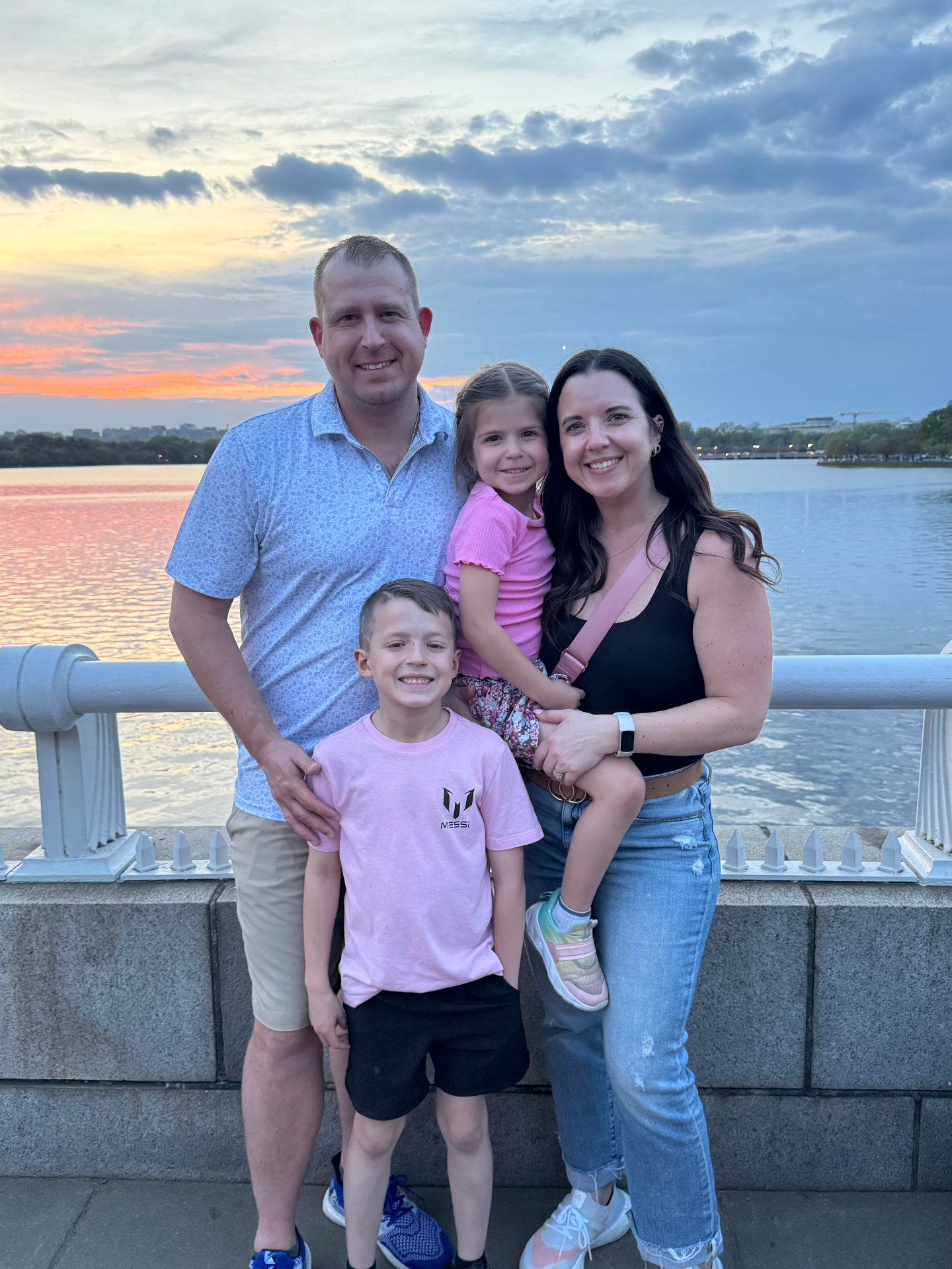 Matt with his family by the water at sunset.